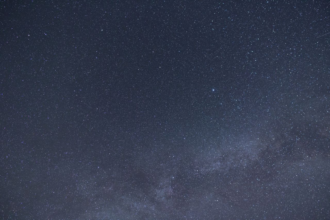 A mesmerizing view of a starry night sky with the Milky Way galaxy visible across the expanse.